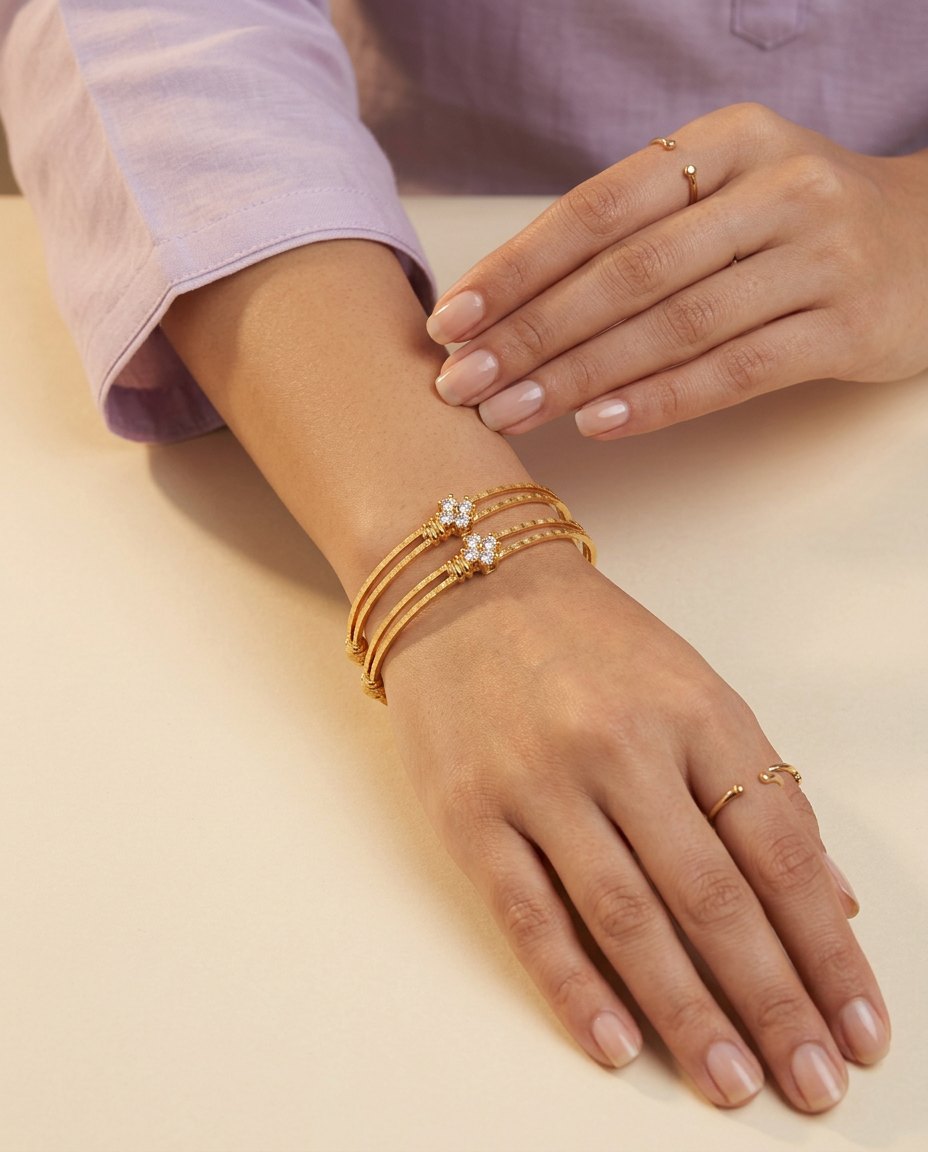 Model wearing the Chameli slim textured gold bangles with crystal flower