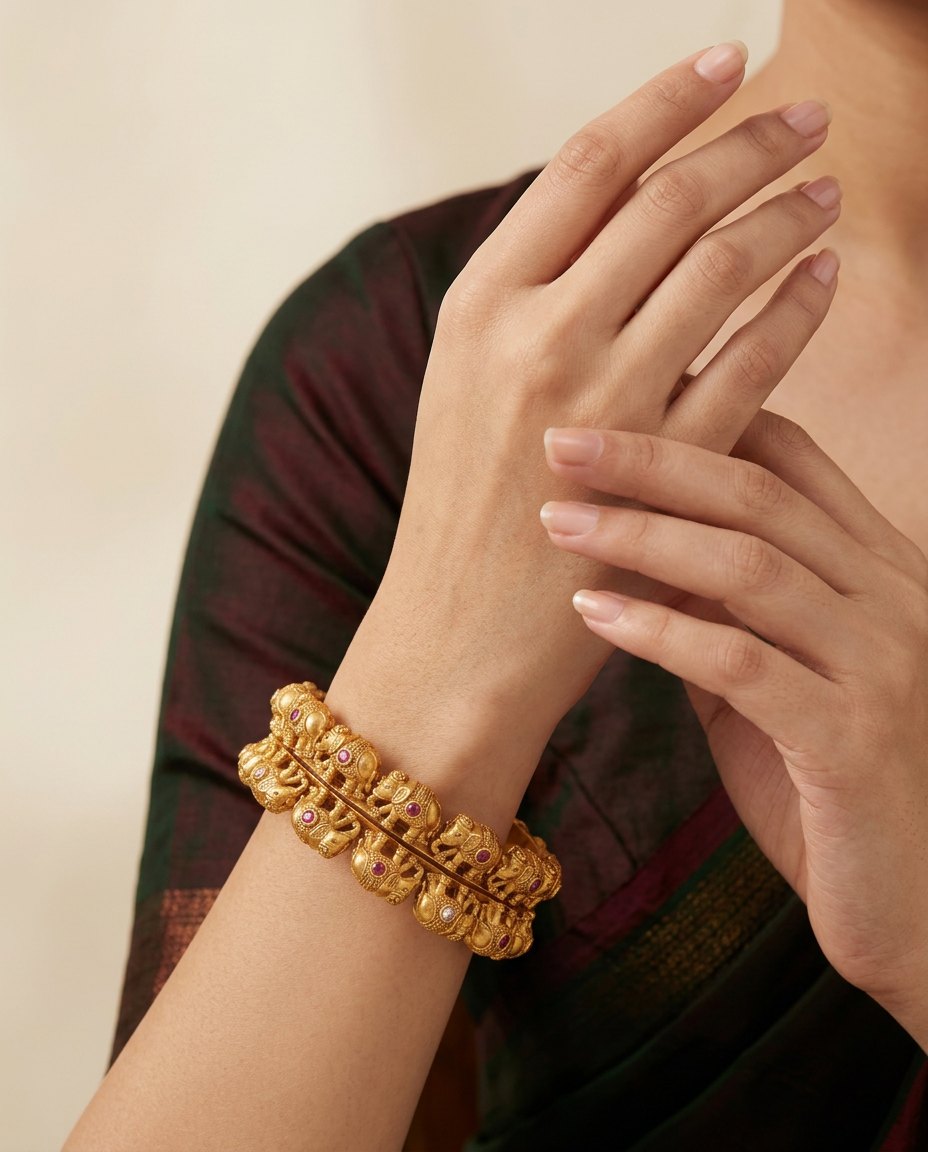 Model wearing the Gaja antique-gold elephant motif bangles