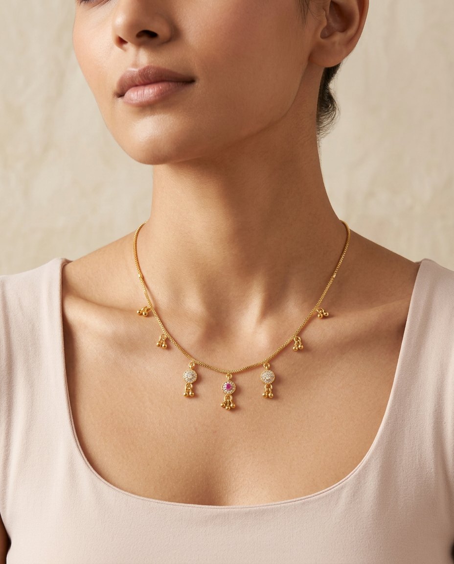 Model wearing the Jhalar fine gold chain necklace with stone and droplet charms
