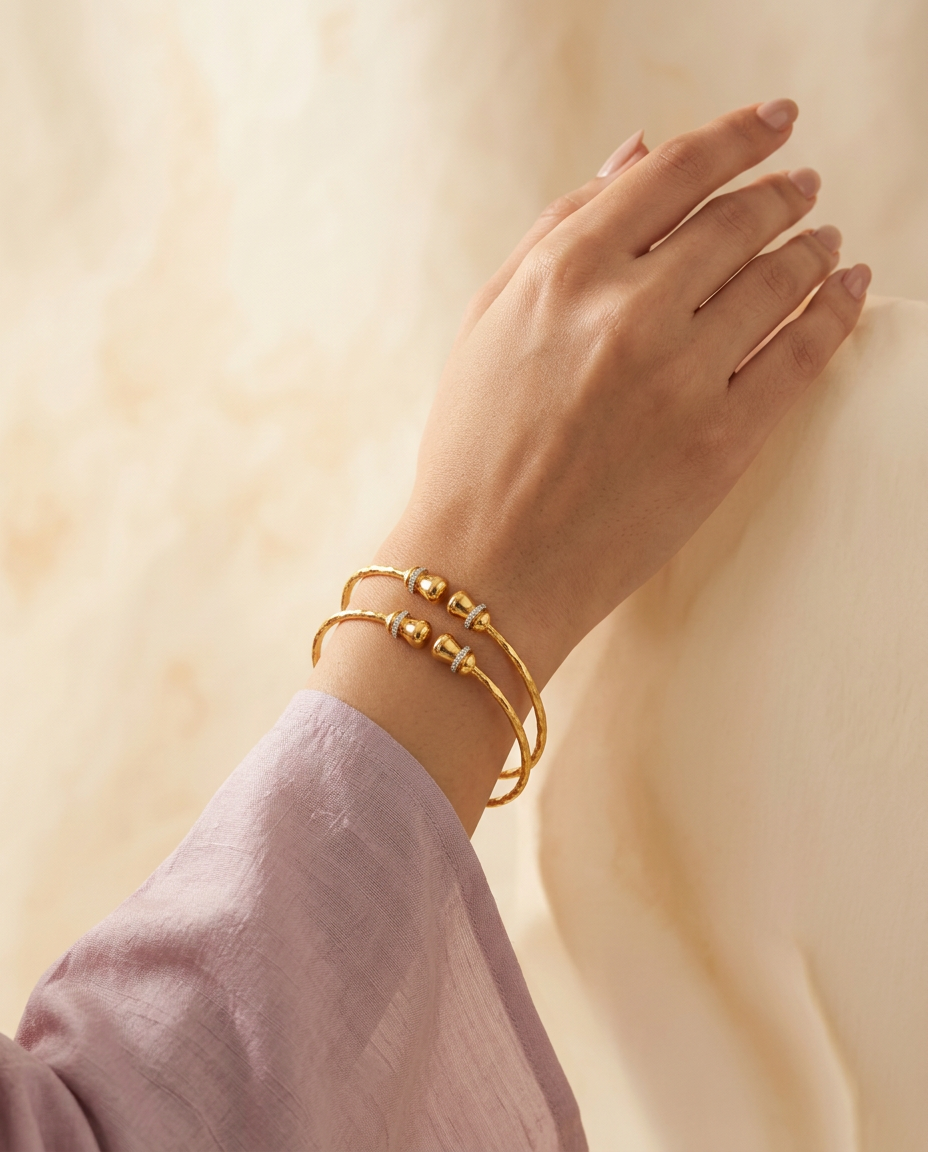 Model wearing the Kangan slim hammered gold bangles with droplet tips