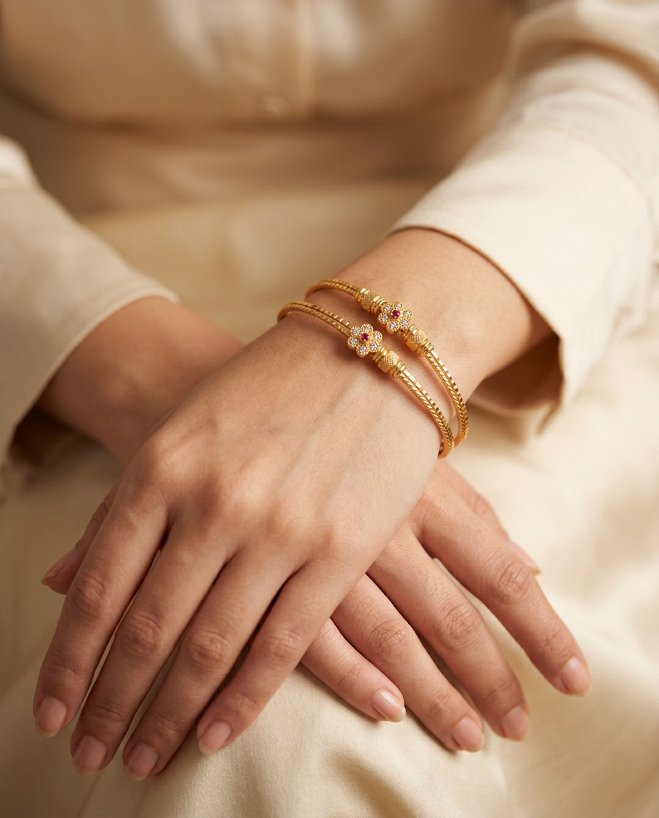 Model wearing the Nazuk fine gold bangles with a ruby flower motif