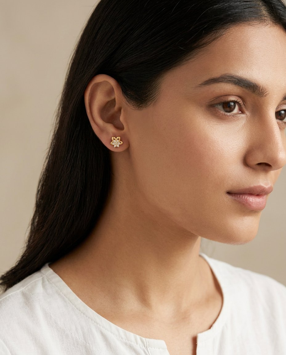 Model wearing one of the Tara Minis tiny gold flower stud earrings